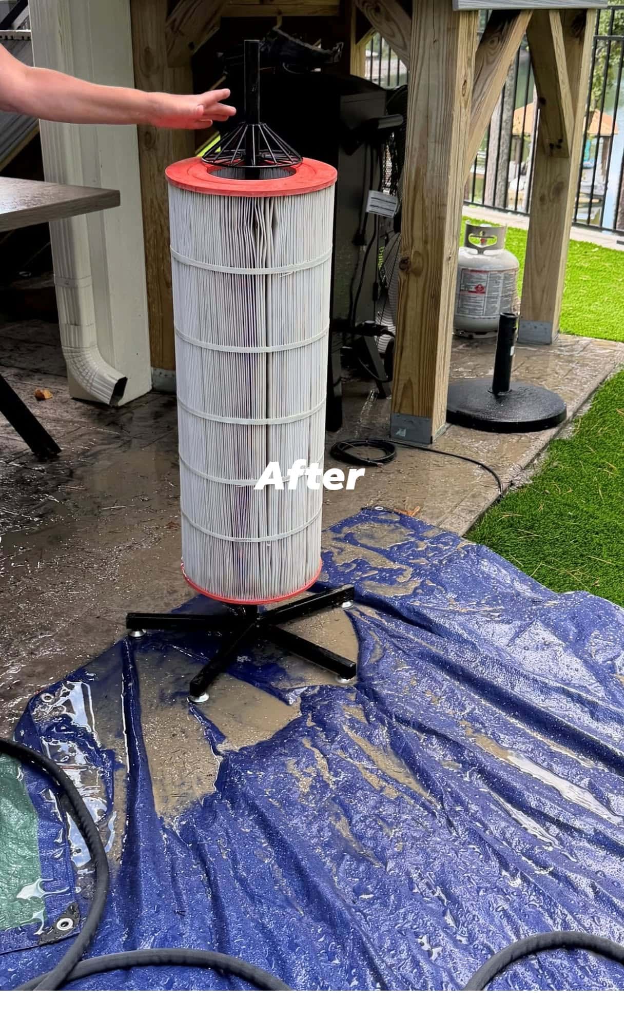 A cleaned cartridge element is held beside pool equipment in a business social photograph.