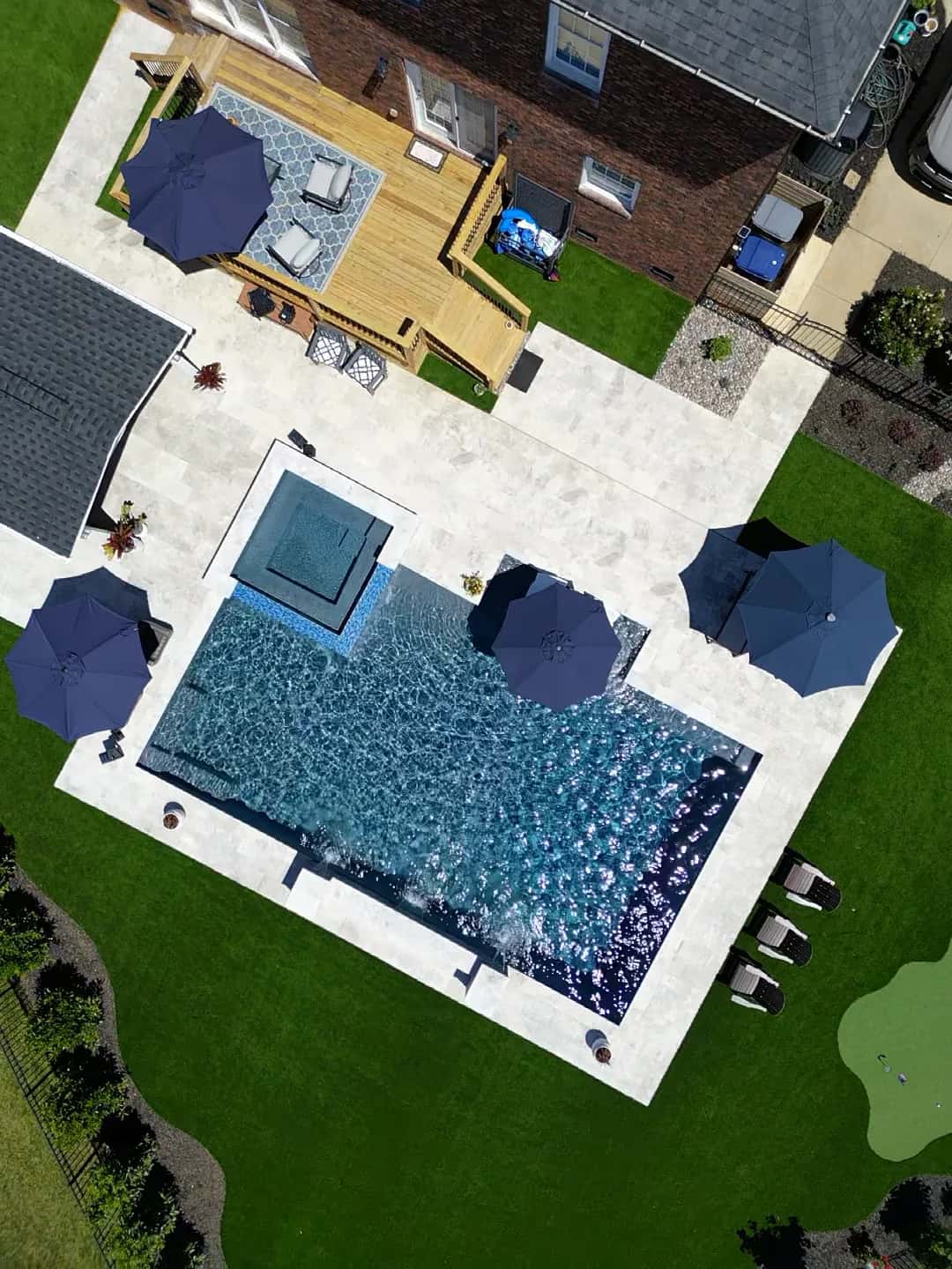 An overhead view shows a rectangular pool with a square attached spa and surrounding deck.